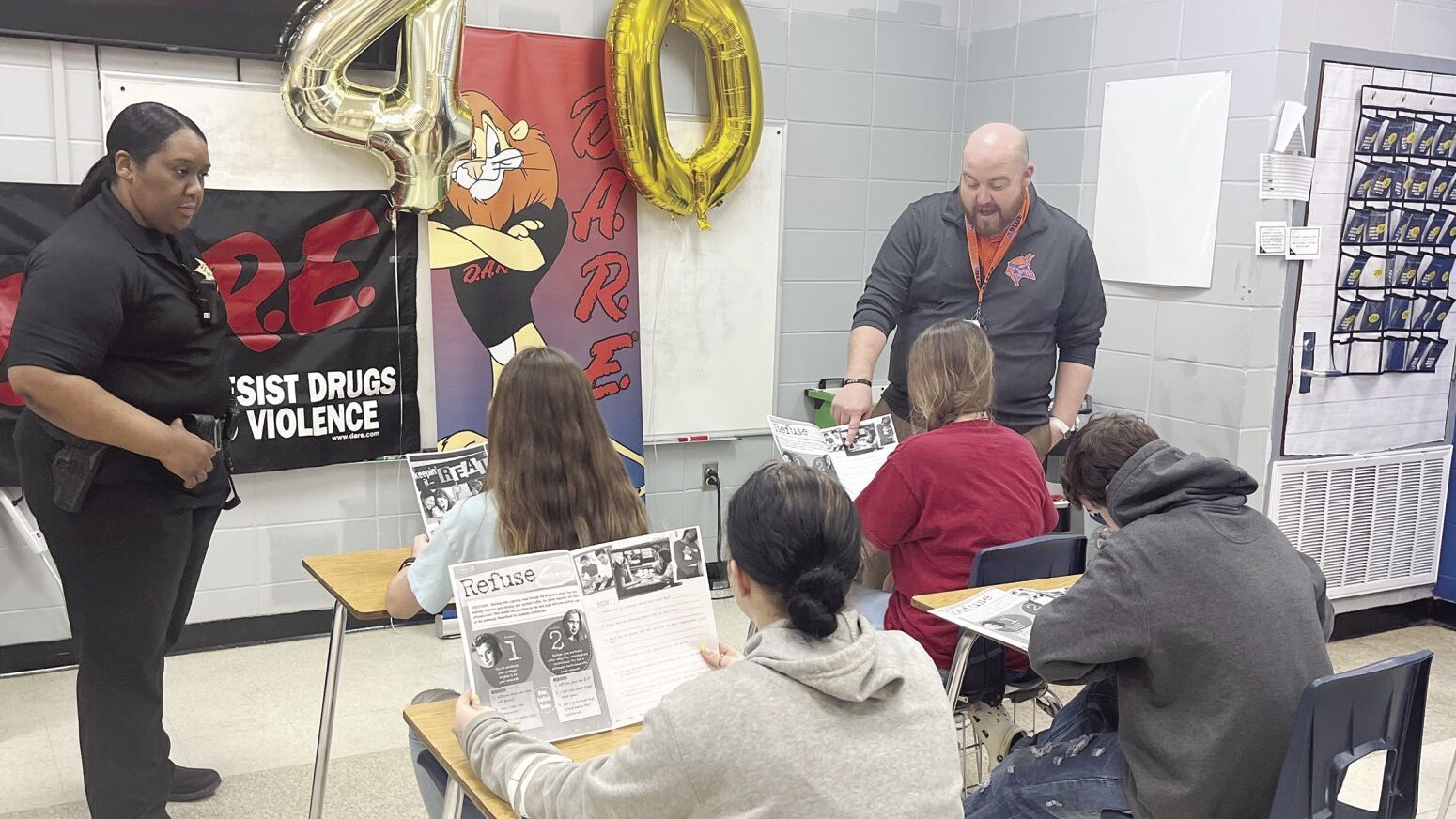 D.A.R.E. Officer Shermila McKinney (left) teaches a group of students at North Pontotoc Middle School. D.A.R.E. lessons include topics on the prevention of drug and alcohol use, violence, bullying, vaping, and internet dangers. North Pontotoc Middle School Principal Jim Matthews (right) routinely visits the D.A.R.E class to show his support and provide encouragement to the students to make good decisions. Students complete their weekly lessons in their D.A.R.E. planners, as they listen and complete tasks as a group.