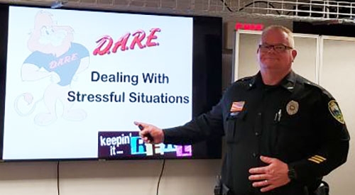Learning more than just resisting drugs ... Lansing Police Chief Conrad Rosendahl stands near the video screen during one of his D.A.R.E. program presentations that he used with Eastern Allamakee Community School District fifth and sixth grade students this past school year. Initially started as a program designed specifically for drug abuse resistance, the D.A.R.E. program has been revamped in the past decade to also include such matters as bullying and healthy lifestyle choices, along with coping and communication skills, risk assessment and other mental and emotional topics.