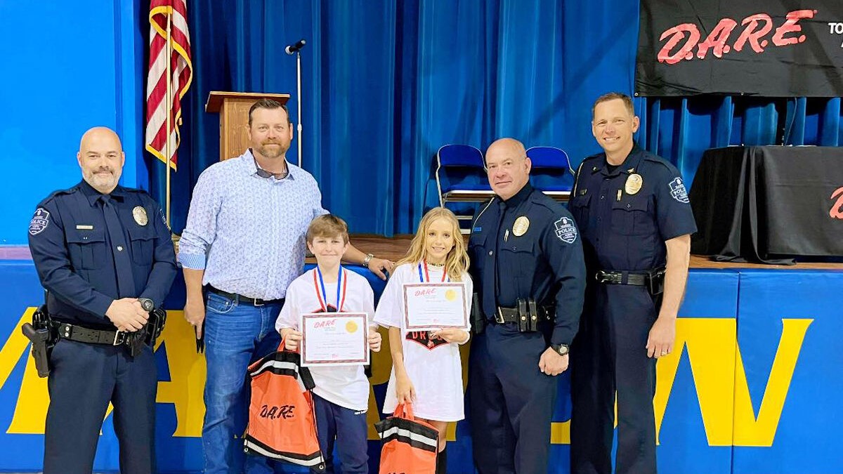 Marion Elementary students Jack Ross, Emily Coram and Kasey Allison (not pictured) were winners of an essay contest at the Marion Elementary School D.A.R.E. graduation ceremony. Pictured with them are Marion Police Officer Jon Padgett, Donnie Suttles, Marion Elementary SRO Mike Hensley and Marion Police Chief Allen Lawrence.