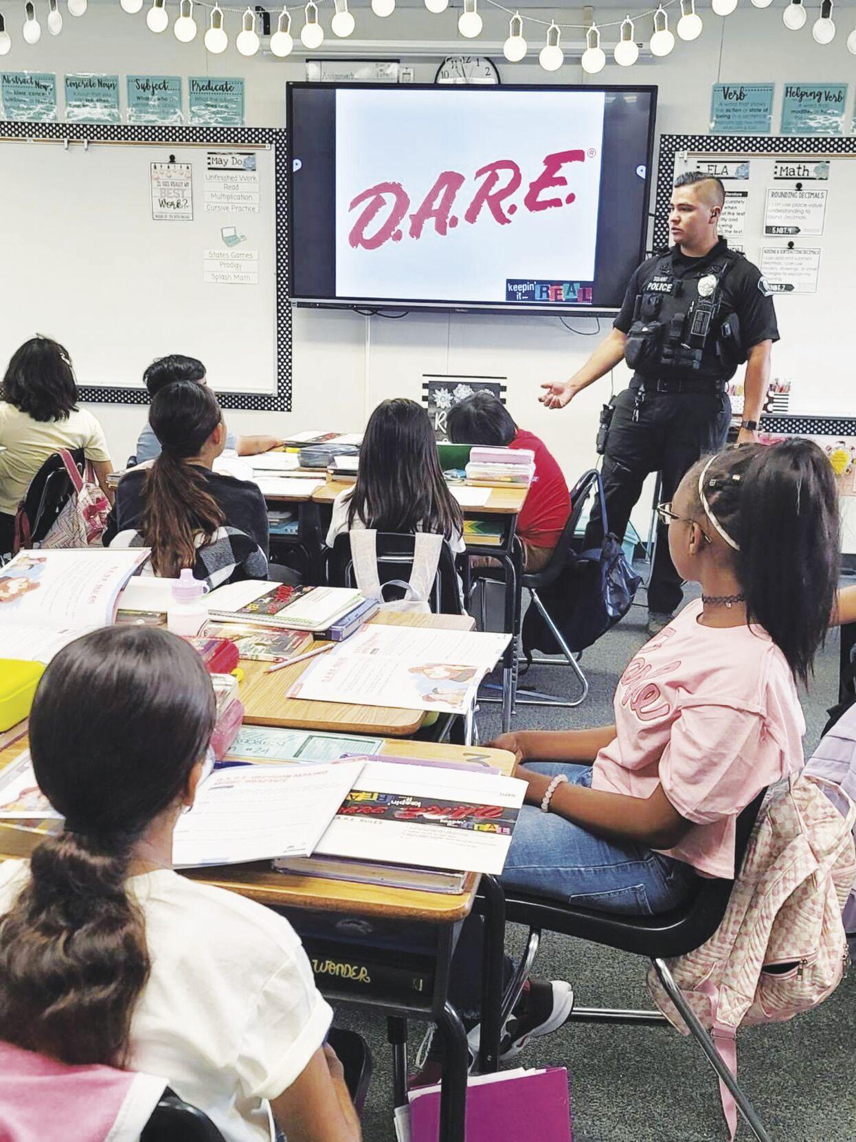 Officer Matthew Solano is shown teaching students drug resistance strategies during the inaugural DARE class at the Cal Aero Preserve Academy in Chino on Aug. 9. Chino Valley School District photo