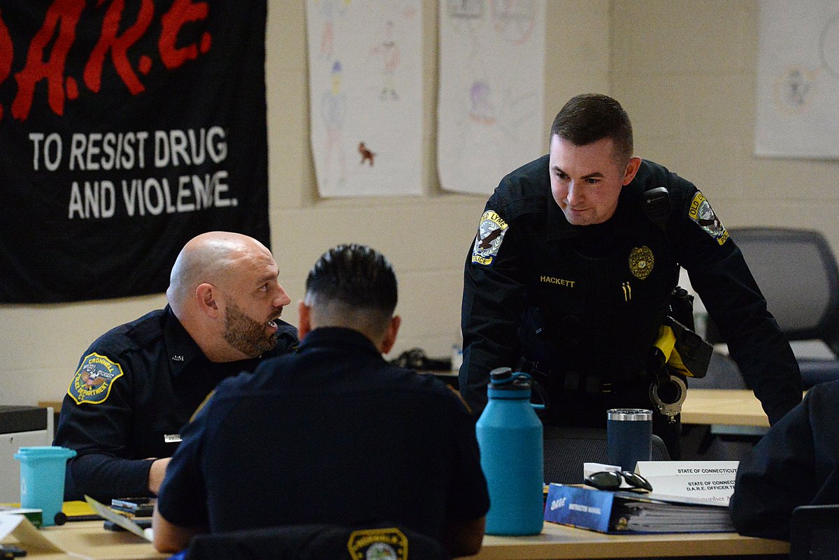 Old Lyme officer Stephen Hackett, right, talks to fellow officers during his DARE presentation Wednesday at the Connecticut State Police Training Academy in Meriden